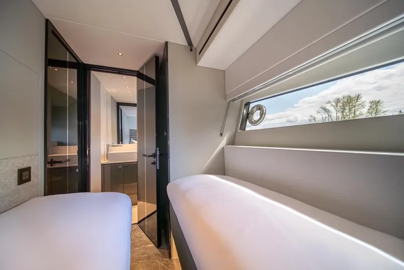 Slide: The Image of Luxurious interior of 2025 Sunseeker Predator 55 yacht cabin with modern design and natural light. - 55