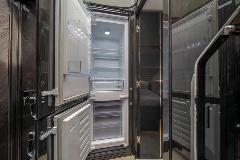 Slide: The Image of Open refrigerator inside 2025 Sunseeker Predator 55 yacht, showcasing modern interior design. - 58