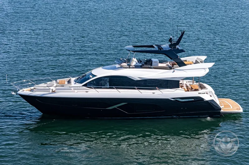 Slide: The Image of 2025 Sunseeker Manhattan 68 luxury yacht on calm water. - 12