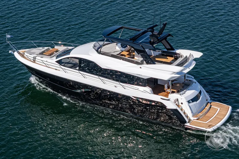 Slide: The Image of 2025 Sunseeker Manhattan 68 luxury yacht cruising on open water. - 14