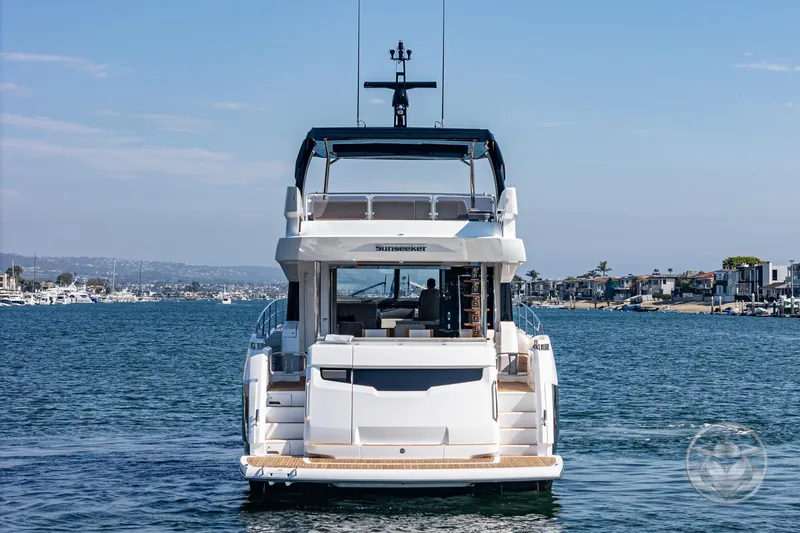 Slide: The Image of Sunseeker Manhattan 68 yacht, 2025 model, cruising on a serene waterway. - 15