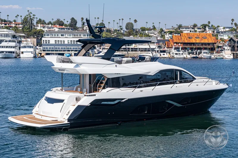 Slide: The Image of 2025 Sunseeker Manhattan 68 luxury yacht on a scenic waterfront. - 17