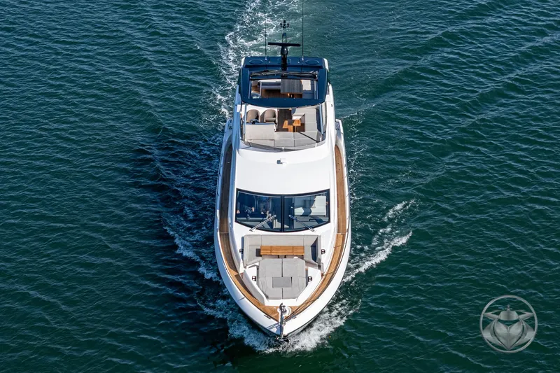 Slide: The Image of 2025 Sunseeker Manhattan 68 yacht cruising on open water, aerial view. - 21