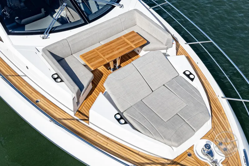 Slide: The Image of Luxurious Sunseeker Manhattan 68 yacht deck with elegant seating and wooden table, 2025 model. - 24