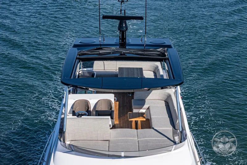 Slide: The Image of Sunseeker Manhattan 68 yacht 2025, top view, luxurious seating, open sea background. - 25