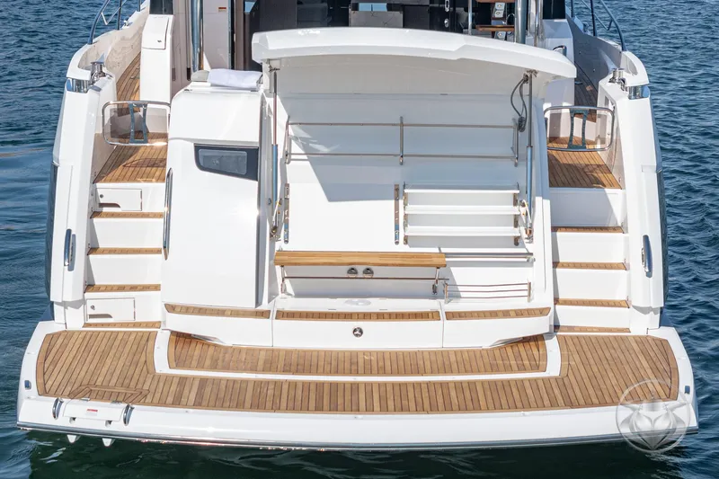 Slide: The Image of 2025 Sunseeker Manhattan 68 yacht, rear view with teak deck and swim platform. - 34