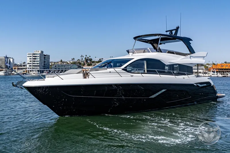 Slide: The Image of 2025 Sunseeker Manhattan 68 yacht cruising in a sunny harbor. - 9