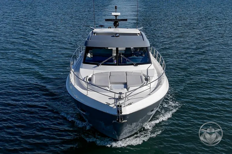 Slide: The Image of 2026 Riviera 4600 Sport Yacht Platinum Edition cruising on open water. - 10