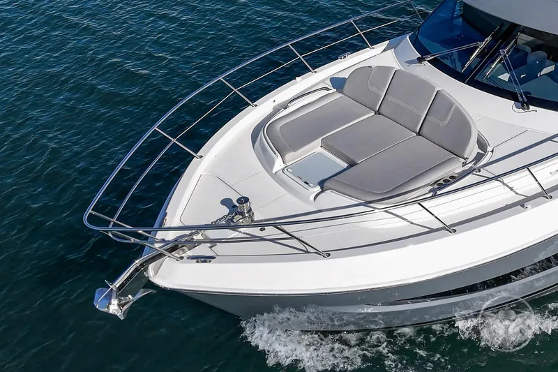 Slide: The Image of 2026 Riviera 4600 Sport Yacht Platinum Edition cruising on open water. - 12