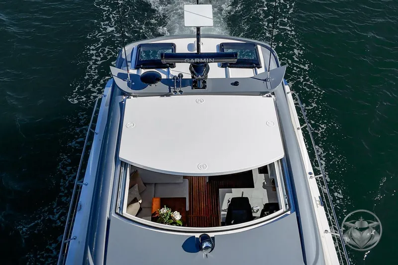 Slide: The Image of Aerial view of 2026 Riviera 4600 Sport Yacht Platinum Edition cruising on water. - 14