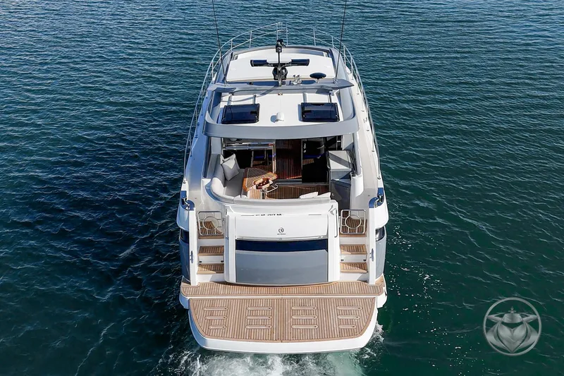 Slide: The Image of 2026 Riviera 4600 Sport Yacht Platinum Edition cruising on open water. - 15