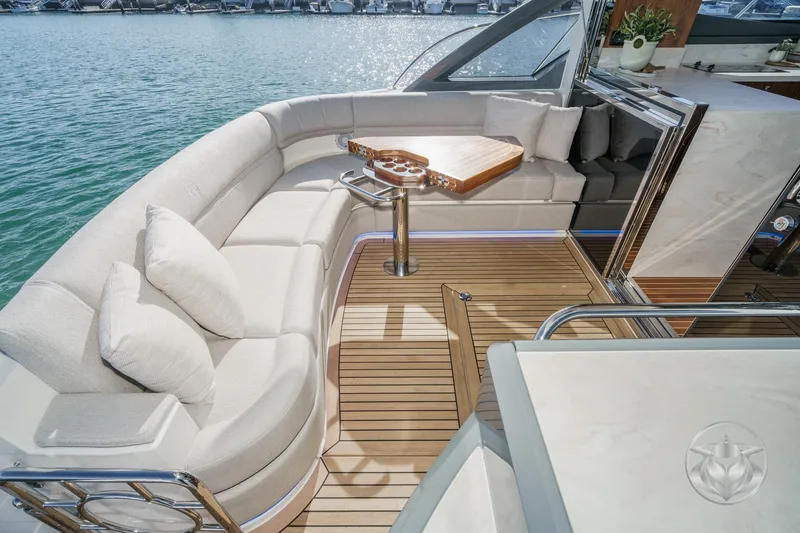 Slide: The Image of Luxurious 2026 Riviera 4600 Sport Yacht Platinum Edition with elegant seating and teak flooring. - 23