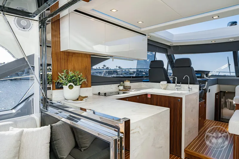 Slide: The Image of Luxurious interior of 2026 Riviera 4600 Sport Yacht Platinum Edition with modern kitchen design. - 27