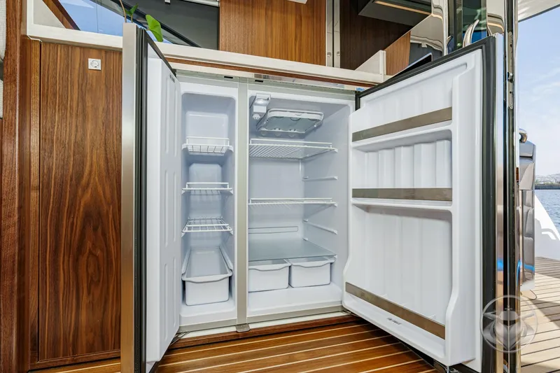 Slide: The Image of Open refrigerator on 2026 Riviera 4600 Sport Yacht Platinum Edition, showcasing spacious interior. - 32
