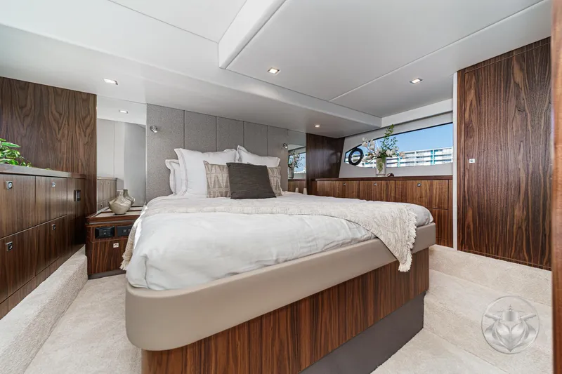 Slide: The Image of Luxurious bedroom interior of 2026 Riviera 4600 Sport Yacht Platinum Edition with elegant wood finishes. - 42