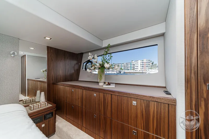 Slide: The Image of Luxurious interior of 2026 Riviera 4600 Sport Yacht Platinum Edition with elegant wood cabinetry. - 46