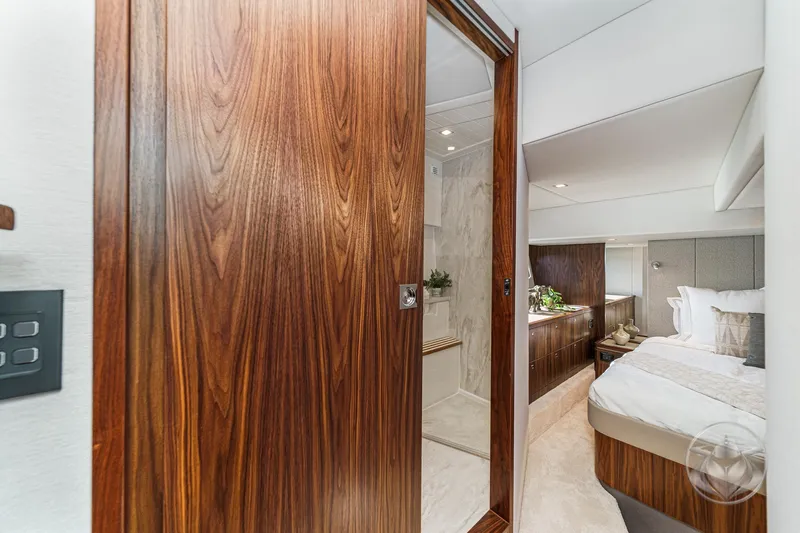 Slide: The Image of Luxurious interior of 2026 Riviera 4600 Sport Yacht Platinum Edition bedroom and bathroom. - 47