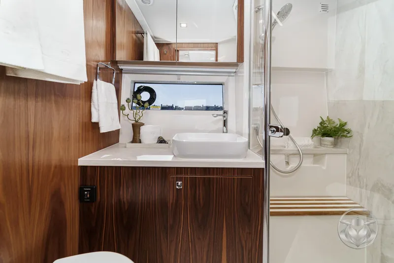 Slide: The Image of Luxurious bathroom in 2026 Riviera 4600 Sport Yacht Platinum Edition with modern fixtures and wood accents. - 48
