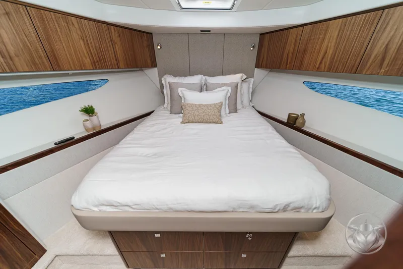 Slide: The Image of Luxurious bedroom interior of 2026 Riviera 4600 Sport Yacht Platinum Edition with elegant wood finishes. - 49
