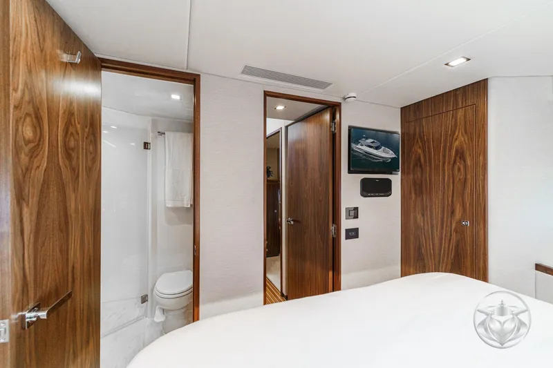 Slide: The Image of Luxurious interior of 2026 Riviera 4600 Sport Yacht Platinum Edition with wood accents and ensuite bathroom. - 51