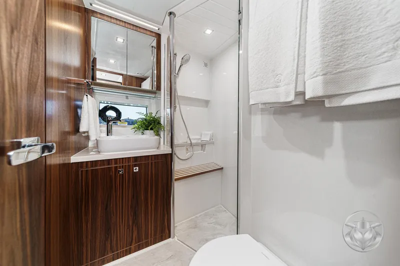 Slide: The Image of Luxurious bathroom in 2026 Riviera 4600 Sport Yacht Platinum Edition with modern fixtures and wood accents. - 52