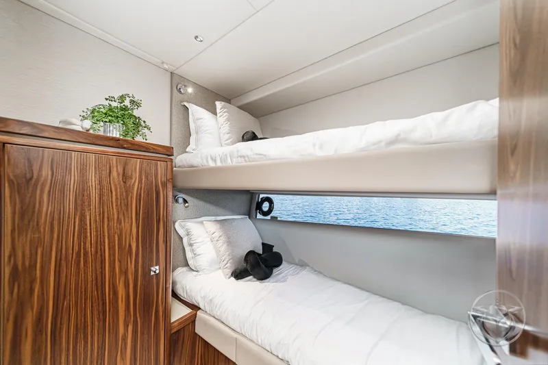 Slide: The Image of Luxurious cabin with bunk beds in 2026 Riviera 4600 Sport Yacht Platinum Edition. - 53