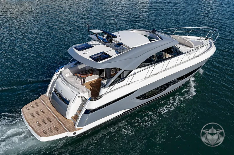Slide: The Image of 2026 Riviera 4600 Sport Yacht Platinum Edition cruising on open water. - 6