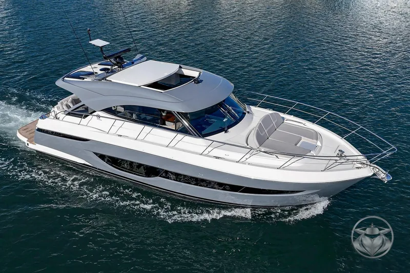 Slide: The Image of 2026 Riviera 4600 Sport Yacht Platinum Edition cruising on open water. - 9