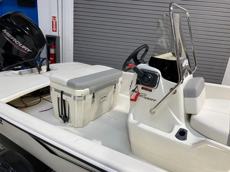 Slide: The Image of 2023 Mako Pro Skiff 15 CC boat interior with console and seating. - 1