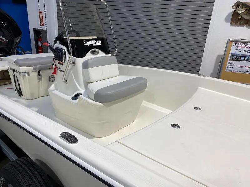 Slide: The Image of 2023 Mako Pro Skiff 15 CC boat interior with console and seating. - 2