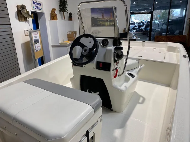 Slide: The Image of 2023 Mako Pro Skiff 15 CC boat interior with steering console and seating. - 3