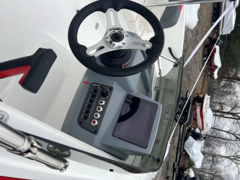 Slide: The Image of 2023 Tahoe T16 boat dashboard with steering wheel and control panel. - 3