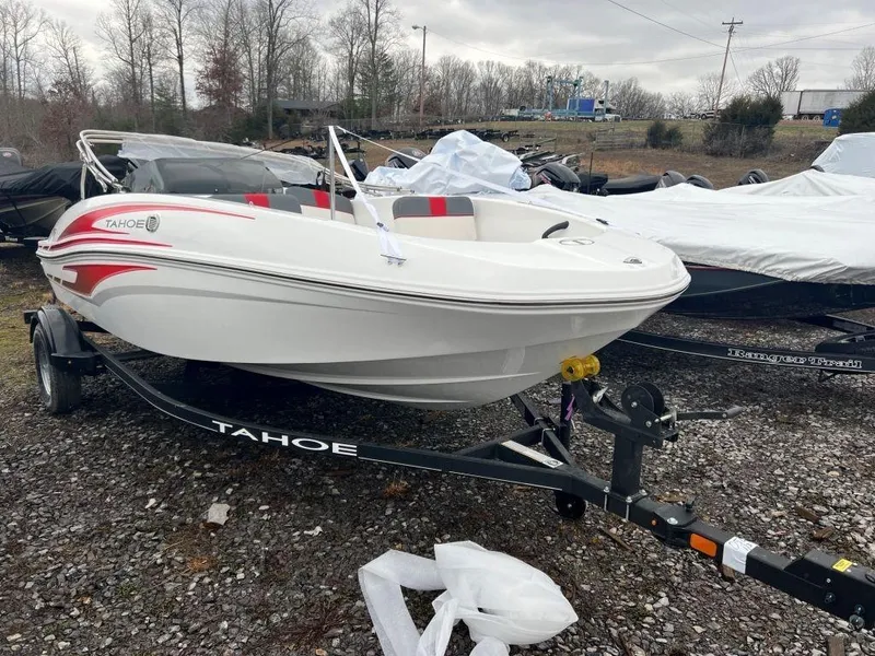Slide: The Image of 2023 Tahoe T16 boat on trailer, parked outdoors. - 5