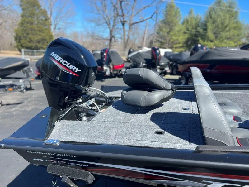 Slide: The Image of 2023 Tracker Pro Team 175 TXW® boat with Mercury engine, parked outdoors. - 3