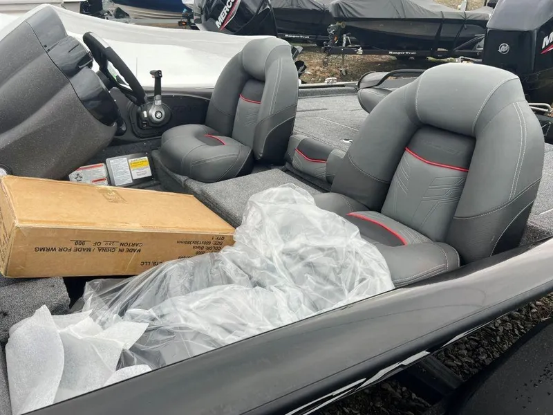 Slide: The Image of 2023 Tracker Pro Team 175 TF® boat interior with gray seats and steering console. - 3