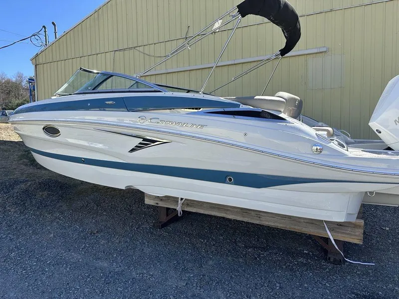 The Image of 2024 Crownline XSS Series 250 boat on display outside a yellow building. - 0