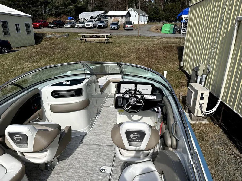 Slide: The Image of 2024 Crownline XSS Series 250 boat interior with steering wheel and seating. - 9