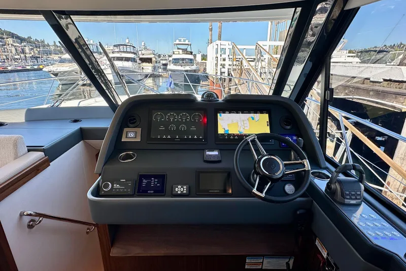 Slide: The Image of 2026 Riviera 505 SUV yacht on clear blue water, showcasing luxurious deck and seating area. - 12