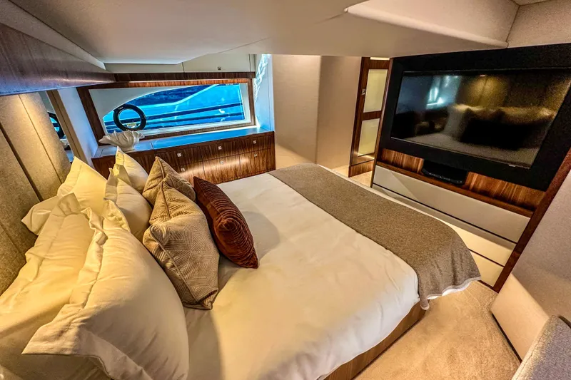 Slide: The Image of 2026 Riviera 505 SUV luxury yacht cruising on open water, showcasing sleek design and spacious deck. - 15