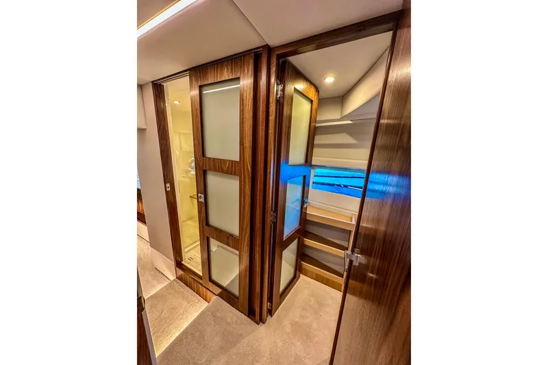 Slide: The Image of 2026 Riviera 505 SUV yacht cruising on a serene lake with lush greenery. - 16