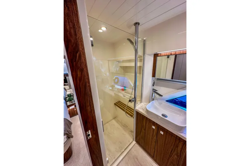 Slide: The Image of Luxurious wooden table on 2026 Riviera 505 SUV yacht, featuring integrated cup holders. - 23