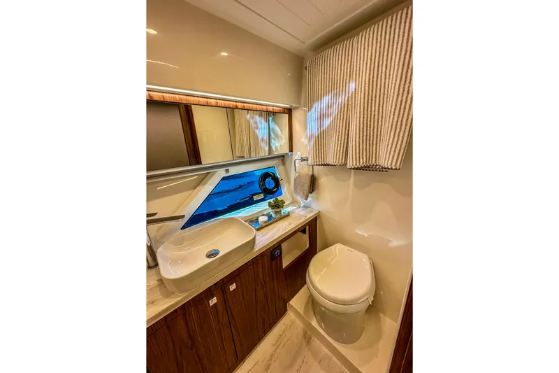 Slide: The Image of Luxurious interior of 2026 Riviera 505 SUV yacht with modern furnishings and panoramic windows. - 24