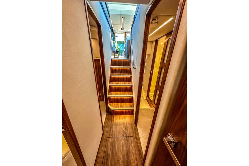 Slide: The Image of Luxurious interior of 2026 Riviera 505 SUV yacht with modern kitchen and scenic water view. - 26