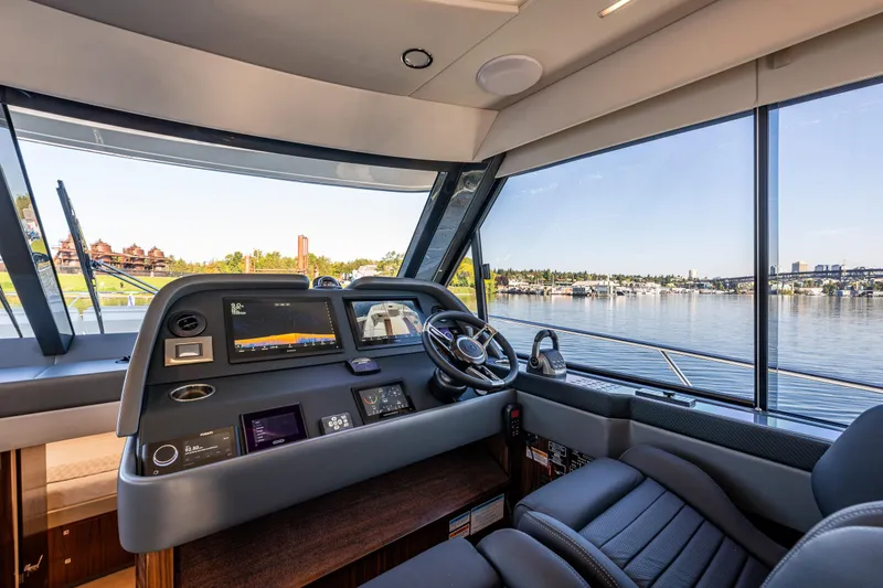 Slide: The Image of Helm of 2026 Riviera 505 SUV yacht with modern navigation displays and waterfront view. - 33