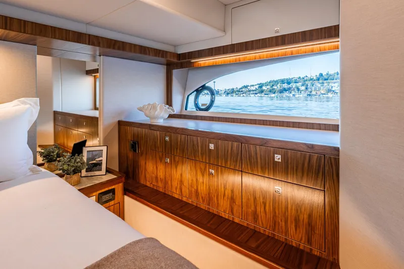 Slide: The Image of Luxurious interior of 2026 Riviera 505 SUV yacht with elegant wood cabinetry and scenic window view. - 40