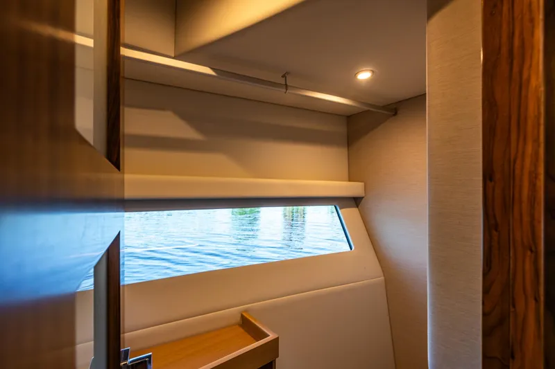 Slide: The Image of Interior view of 2026 Riviera 505 SUV yacht cabin with window overlooking water. - 41