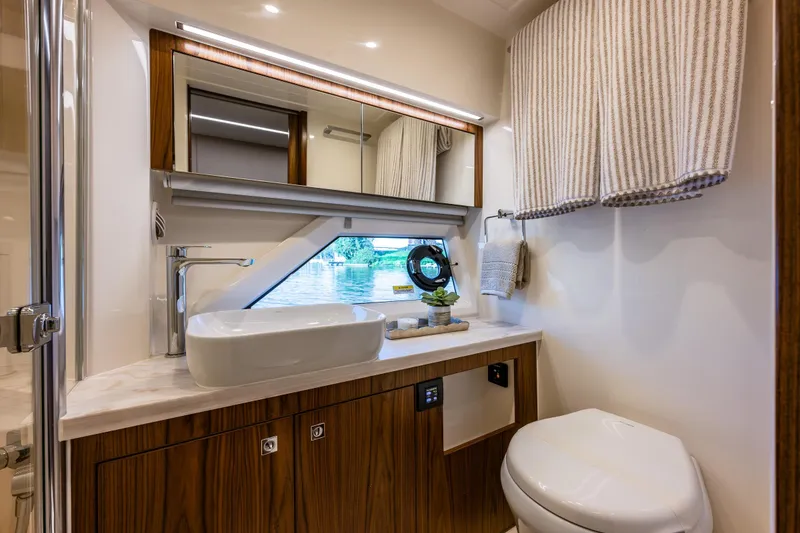 Slide: The Image of Luxurious bathroom in 2026 Riviera 505 SUV yacht with modern fixtures and elegant design. - 42
