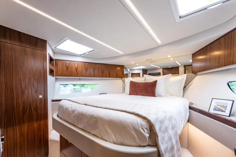 Slide: The Image of Luxurious bedroom interior of 2026 Riviera 505 SUV yacht with elegant wood finishes. - 44