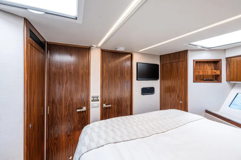 Slide: The Image of Luxurious interior of 2026 Riviera 505 SUV yacht bedroom with wood paneling and modern amenities. - 45