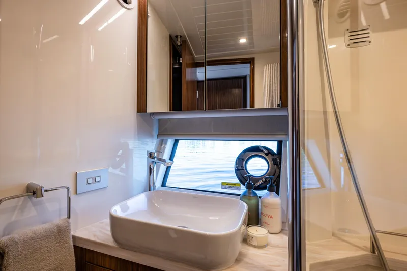 Slide: The Image of Luxurious bathroom interior of 2026 Riviera 505 SUV yacht with modern sink and window view. - 47